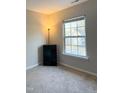 Bright bedroom with carpeted floor, large window, and a small storage unit at 4232 Vienna Crest Dr, Raleigh, NC 27613