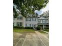 Two story townhomes with neutral and brick siding, green shutters, and a manicured lawn at 4232 Vienna Crest Dr, Raleigh, NC 27613