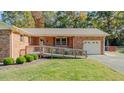 Brick ranch house with attached garage and ramp at 5036 Autumn Dr, Durham, NC 27712