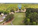 An aerial view of a neighborhood golf course with mature trees at 5101 Hogans Way, Clayton, NC 27520