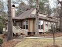 Charming, light-yellow two-story home with a brick chimney and inviting front porch at 5101 Hogans Way, Clayton, NC 27520