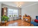 Bright dining room featuring hardwood floors, large window, and elegant decor at 701 Brickstone Dr, Apex, NC 27502