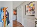 Entryway with hardwood floors, coat rack, white molding, and a closet at 701 Brickstone Dr, Apex, NC 27502