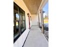 Side view of the front porch featuring a covered ceiling, black railings, and modern lighting fixtures at 727 Cook Rd, Durham, NC 27713