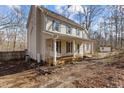 Two story house with blue shutters and a wooden porch at 96 Double Oak Dr, Pittsboro, NC 27312