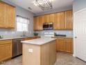 Bright kitchen featuring granite countertops, stainless steel appliances, and island at 125 Watertree Ln, Apex, NC 27502