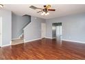 Open living area with hardwood floors, staircase, and neutral wall color at 125 Watertree Ln, Apex, NC 27502