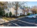 Condo building exterior showcasing multiple units, landscaping, and parking spaces at 1300 Durlain Dr # 108, Raleigh, NC 27614