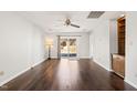 Living room with dark hardwood floors and sliding glass doors at 3125 Quinley Pl, Raleigh, NC 27604