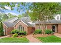 Charming brick home with landscaped front yard, a brick walkway, and mature tree at 3347 Ridgecrest Ct, Raleigh, NC 27607