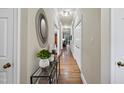 Inviting hallway with hardwood floors, neutral walls, and stylish decorative accents at 3347 Ridgecrest Ct, Raleigh, NC 27607