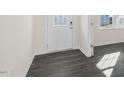 Bright entryway with gray vinyl plank flooring and a glass door at 435 Blue Aspen Dr, Fuquay Varina, NC 27526