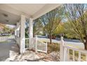 Relaxing covered porch view showcases neighborhood street and lush, mature trees at 4703 Paces Ferry Dr, Durham, NC 27712