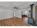 Bright living room with wood-look floors, fireplace and open-concept to the kitchen at 593 Bailey Rd, Coats, NC 27521