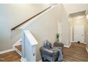 Inviting entryway with wood flooring, a staircase, and a stylish bench adorned with plush pillows at 12408 Angel Vale Pl, Durham, NC 27703