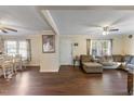 Spacious living room with hardwood floors, L-shaped sofa, and large TV at 1508 Carroll Heights Rd, Zebulon, NC 27597