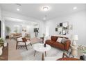 Spacious living room with a leather couch and open floor plan at 2908 Huxley Way, Apex, NC 27502