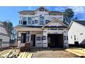 New two-story home under construction with visible framing, windows, and attached garage awaiting finishing touches at 346 Maidenhair Pl, Clayton, NC 27520