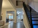 Bright foyer with dark wood flooring, modern staircase, and an open view of the home at 359 Ballast Pt, Clayton, NC 27520