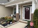 Inviting front porch with decorative plants and string lights, creating a cozy outdoor space at 359 Ballast Pt, Clayton, NC 27520