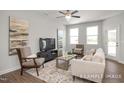 Spacious living room with comfortable seating, media center, and ample natural light from large windows at 3854 Well Fleet Drive, Fuquay Varina, NC 27526