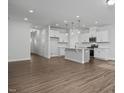Open floor plan featuring a modern kitchen with stainless steel appliances and wood flooring at 3860 Well Fleet Drive, Fuquay Varina, NC 27526