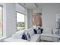 Cozy living room with a comfortable white sofa, stylish pillows, and bright views at 400 W North St # 620, Raleigh, NC 27603