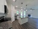 Open-concept kitchen showcases granite countertops, a center island, and stainless steel appliances at 406 Maidenhair Pl, Clayton, NC 27520