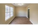 Simple dining area with hardwood floors and large window at 412 N Cooper St, Clayton, NC 27520