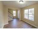 Bright living room with hardwood floors and large windows at 412 N Cooper St, Clayton, NC 27520