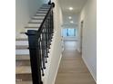 Bright entryway featuring hardwood floors, a staircase with modern railings and neutral paint at 4318 Emeline Ln # 20, Fuquay Varina, NC 27526