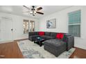 Spacious living room featuring a comfortable sectional sofa and hardwood floors at 4605 All Points View Way, Raleigh, NC 27614