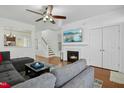 Bright living room with fireplace, hardwood floors, and sectional sofa at 4605 All Points View Way, Raleigh, NC 27614