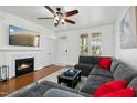 Living room boasts fireplace, hardwood floors, and sectional sofa at 4605 All Points View Way, Raleigh, NC 27614