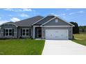 Charming single Gathering home featuring a two-car garage and well-maintained lawn at 565 Sweet Potato Lane # 07, Nashville, NC 27856