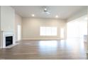Bright and airy living room featuring wood floors, a fireplace and large windows at 565 Sweet Potato Lane # 07, Nashville, NC 27856