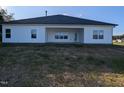 A well-kept house with white vinyl siding, a covered patio, and a yard with newly installed grass at 565 Sweet Potato Lane # 07, Nashville, NC 27856