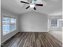 Bright living room with hardwood floors and large windows at 610 Lockwood Dr, Clayton, NC 27527