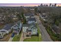 A lovely home shown in an aerial view with a big city skyline in the background at 700 Coleman St, Raleigh, NC 27610