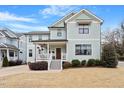 Beautiful two story home with white trim, light colored siding, and a cozy front porch at 700 Coleman St, Raleigh, NC 27610