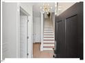 Bright entryway with staircase, light wood floors, and neutral walls at 712 E Edenton St # 105, Raleigh, NC 27601