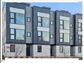 Modern three-story townhouses with gray siding and large windows at 712 E Edenton St # 105, Raleigh, NC 27601