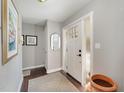 Entryway with white door, hardwood floor, and mirror at 1304 Rothes Rd, Cary, NC 27511