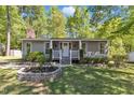 Charming home featuring a manicured front yard and a cozy front porch at 1304 Rothes Rd, Cary, NC 27511