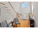 Elegant entryway with hardwood floors, staircase, and seating at 1501 Carrickfergus Ct, Durham, NC 27713