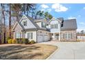 Two-story house with stone and siding, 3-car garage, and manicured lawn at 1620 Dail Dr, Raleigh, NC 27603