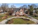 Two story brick home with a large front yard and circular driveway at 2035 Stuart Ct, Burlington, NC 27215