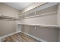 Walk-in closet with multiple levels of shelving for optimal storage and organization at 2115 Titanium Rock Road Rd, Durham, NC 27704