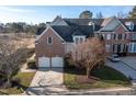 Two-story brick home with a two-car garage and a large backyard at 2328 Carriage Oaks Dr, Raleigh, NC 27614