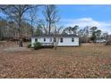 Back exterior view of the home with a wooden deck and a spacious backyard at 2400 Dorety Pl, Raleigh, NC 27604